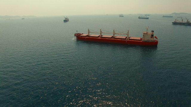aerial view of heavy tanker ship floating over blue ocean 