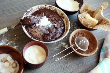 Preparing dough for chocolate pie on table close up