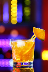 Glass of cocktail on bar background
