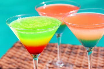 Cocktails on swimming pool background