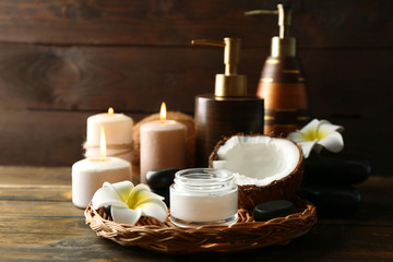 Spa coconut products on dark wooden background