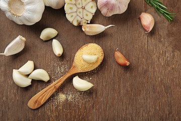 Composition of garlic and rosemary on wooden background