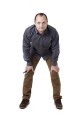 Full length picture of a man standing on studio. Isolated on white background.