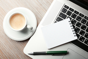 Empty  notebook on laptop keyboard, on light background