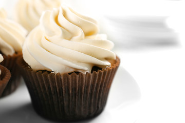 White cupcakes on wooden table