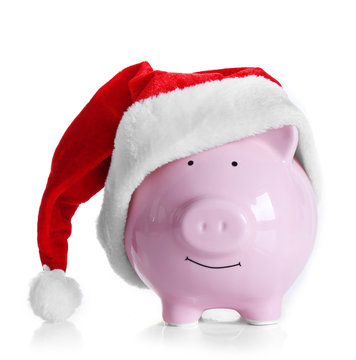 Piggy bank with Santa hat isolated on white