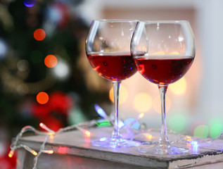 Two glasses of red wine on Christmas decoration background