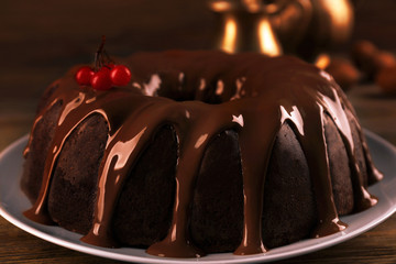 Chocolate cake with snowball tree berries on a table