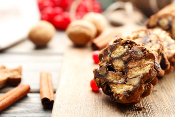 Chocolate salami on a wooden background, close up