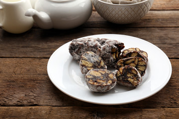 Chocolate salami in a plate over wooden background
