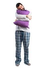 Man in pajamas doing sleep gesture