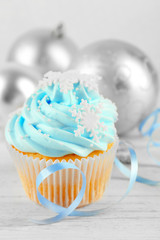 Tasty blue cupcake with decorations, closeup