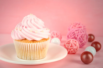 Tasty pink cupcake with decorations, closeup