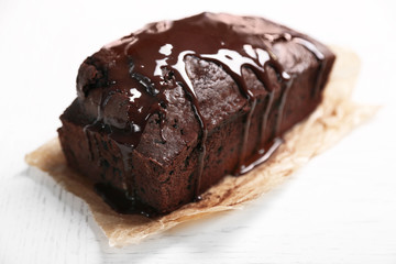 Chocolate cake with icing on white table