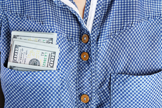 Money in cotton shirt pocket, close up