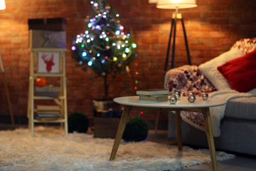 Living room interior with sofa, lamp and Christmas tree on brick wall background