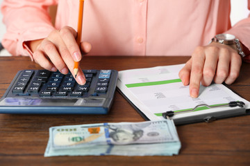 Woman working on financial report at the office, close-up