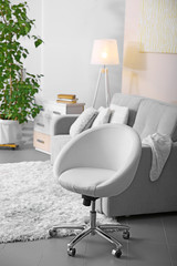 Living room design with armchair and sofa