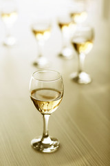 Glasses of wine on wooden blurred background