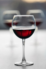 Glass of wine on light blurred background