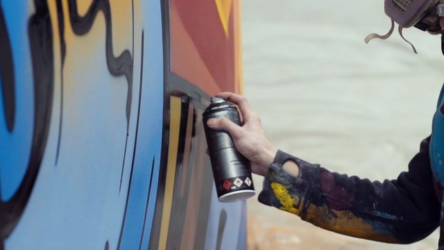 Slow motion graffiti painting on the wall, interior