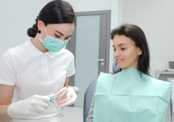 Dentist teaching to brush their teeth in the denture