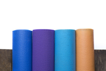 Yoga mats on the wood table and white background