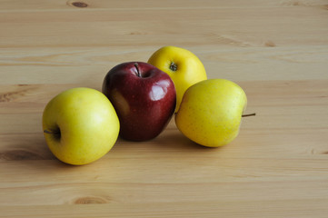 Red and yellow apples in table
