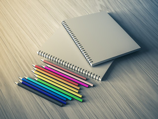 color pencil on checked notebook on wood background