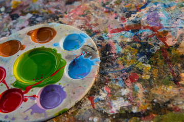 art palette with paint color on dry poster color texture