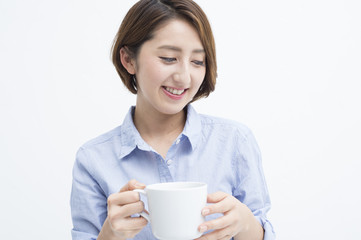 Woman smiling with a white mug