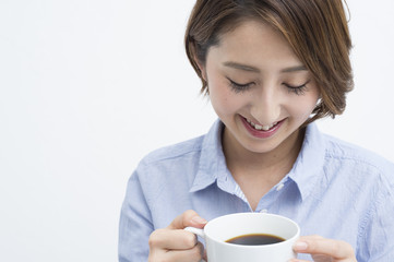 Woman smiling with a white mug