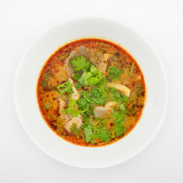 The tasty spicy pork tom yum soup (hot and sour soup) in white ceramic bowl, homemade Thai food.
