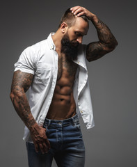 Bearded muscular man in a white shirt.