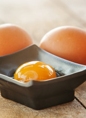 With brown eggs on a white background. One egg is broken.