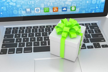 Fototapeta na wymiar Gift box with ribbon on laptop keyboard