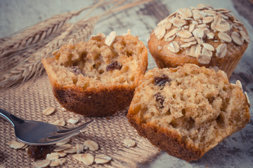 Fototapeta na wymiar Vintage photo, Fresh muffins with oatmeal baked with wholemeal flour and ears of rye grain, delicious healthy dessert