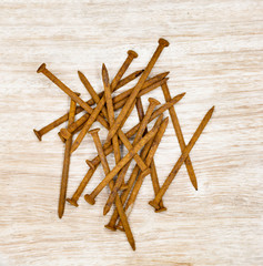 rusty nails on wooden board