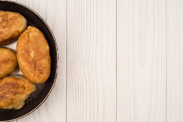 food in a frying pan. from yeast dough. it is a lot of tasty pie