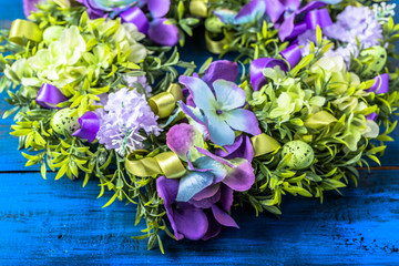 Easter decoration from easter eggs, easter boxwood and flowers.