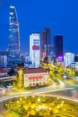 View of the city after sunset with Bitexco Financial Tower on the background in Ben Thanh Market area, District 1, Vietnam.