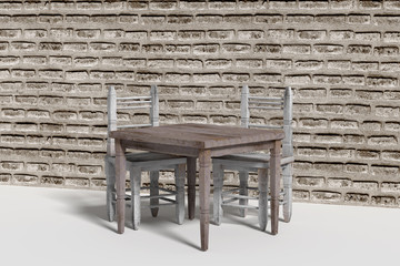 Two old chairs and wooden table against of brick wall