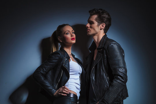 man looking down on sexy woman in leather jacket