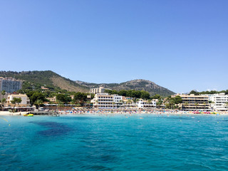Blue ocean in front of large resort