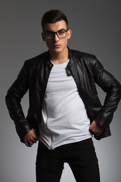 model wearing glasses in studio fixing his jacket