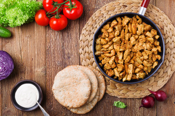 Pita salad with roasted chicken and vegetables, served with a de