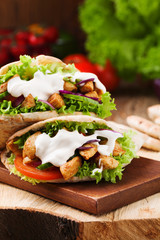Pita salad with roasted chicken and vegetables, served with a de