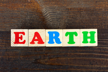 Fototapeta premium the word from children's wooden blocks with colorful letters on wooden table