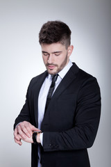 Businessmann im Anzug blickt auf Uhr Porträt