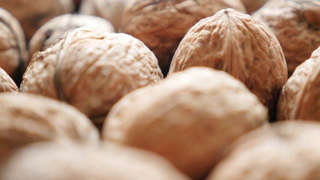 Walnut background of hard shell fruit arranged natural organic food 4K 2160p 30fps UltraHD footage - Juglans regia Juglandaceae family fruit healthy autumn product 